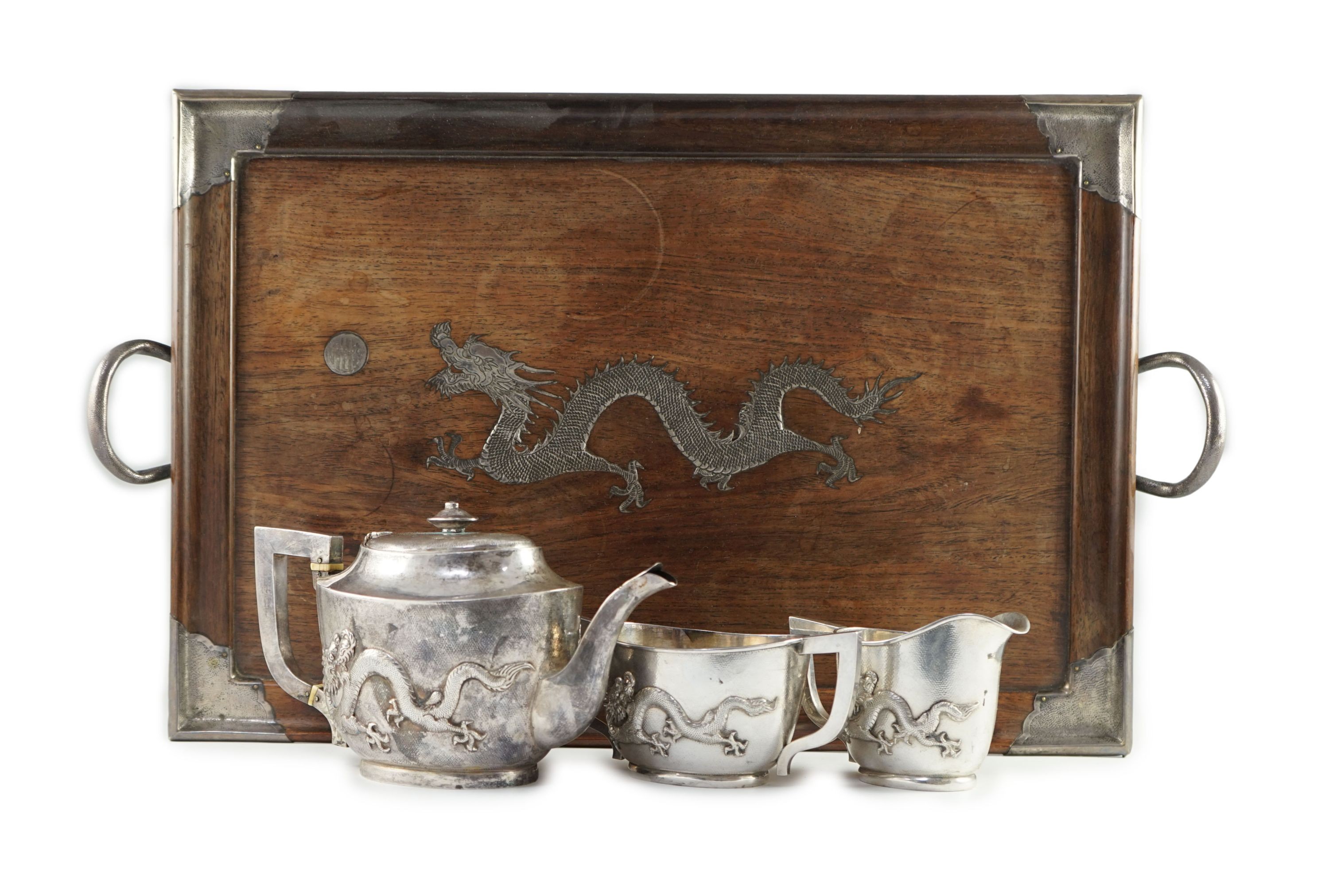 An early 20th century Chinese Export three piece silver tea set and matching silver inlaid hardwood two handled tea tray, by Luen Hing?